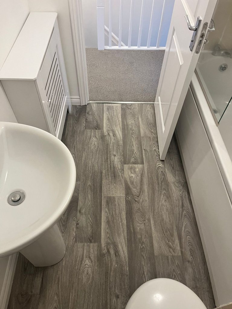 Rental property stairs and landing loop pile carpet grey wood effect vinyl floor 01