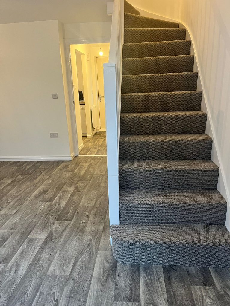 Rental property stairs and landing loop pile carpet grey wood effect vinyl floor 06