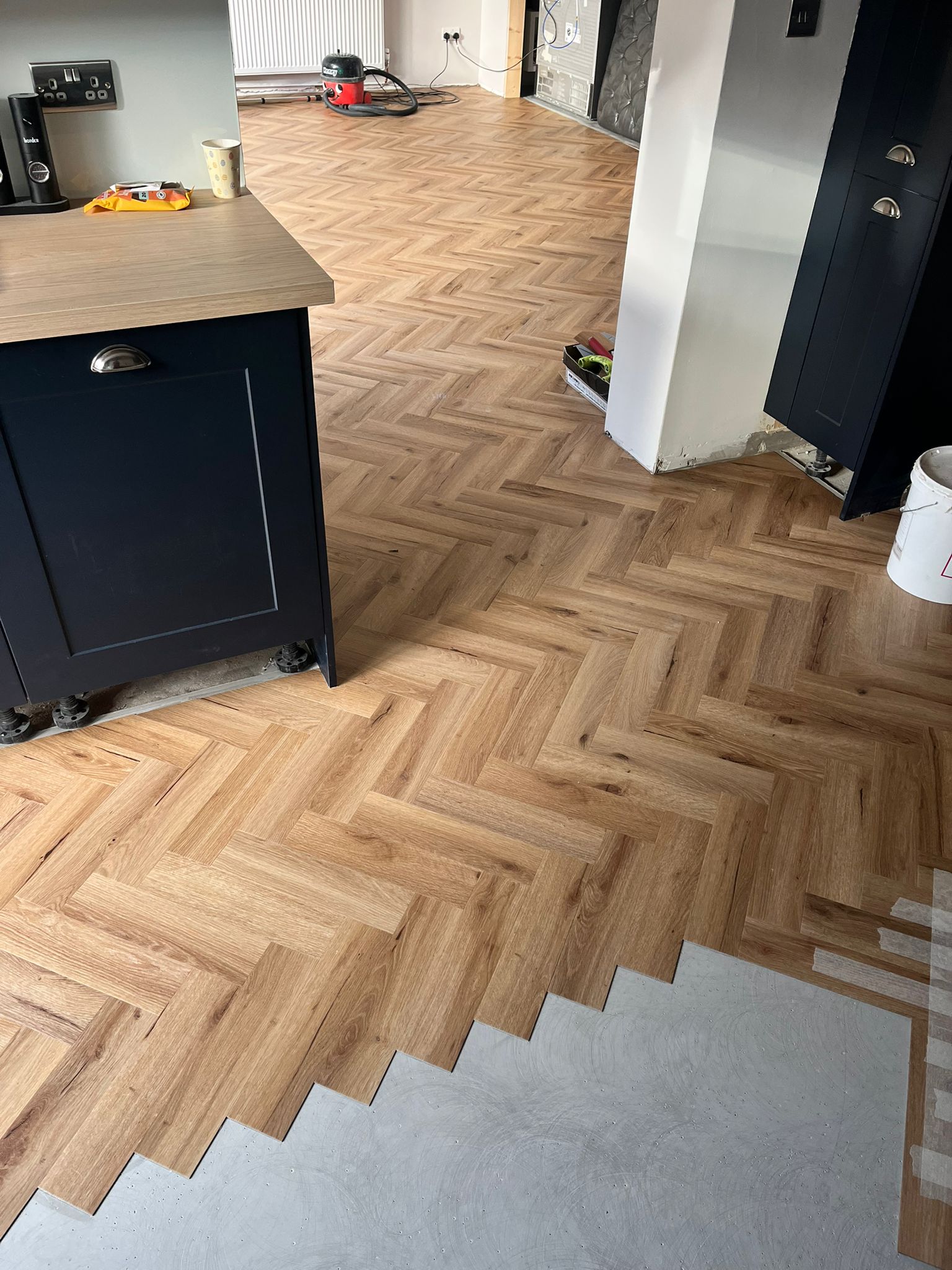 Family room and Kitchen in Textures Herringbone LVT.